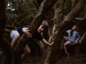 boy and girl in a tree