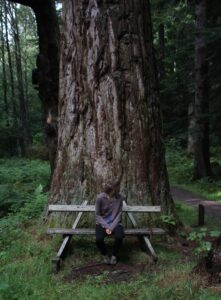 Girl sitting beneath a tree